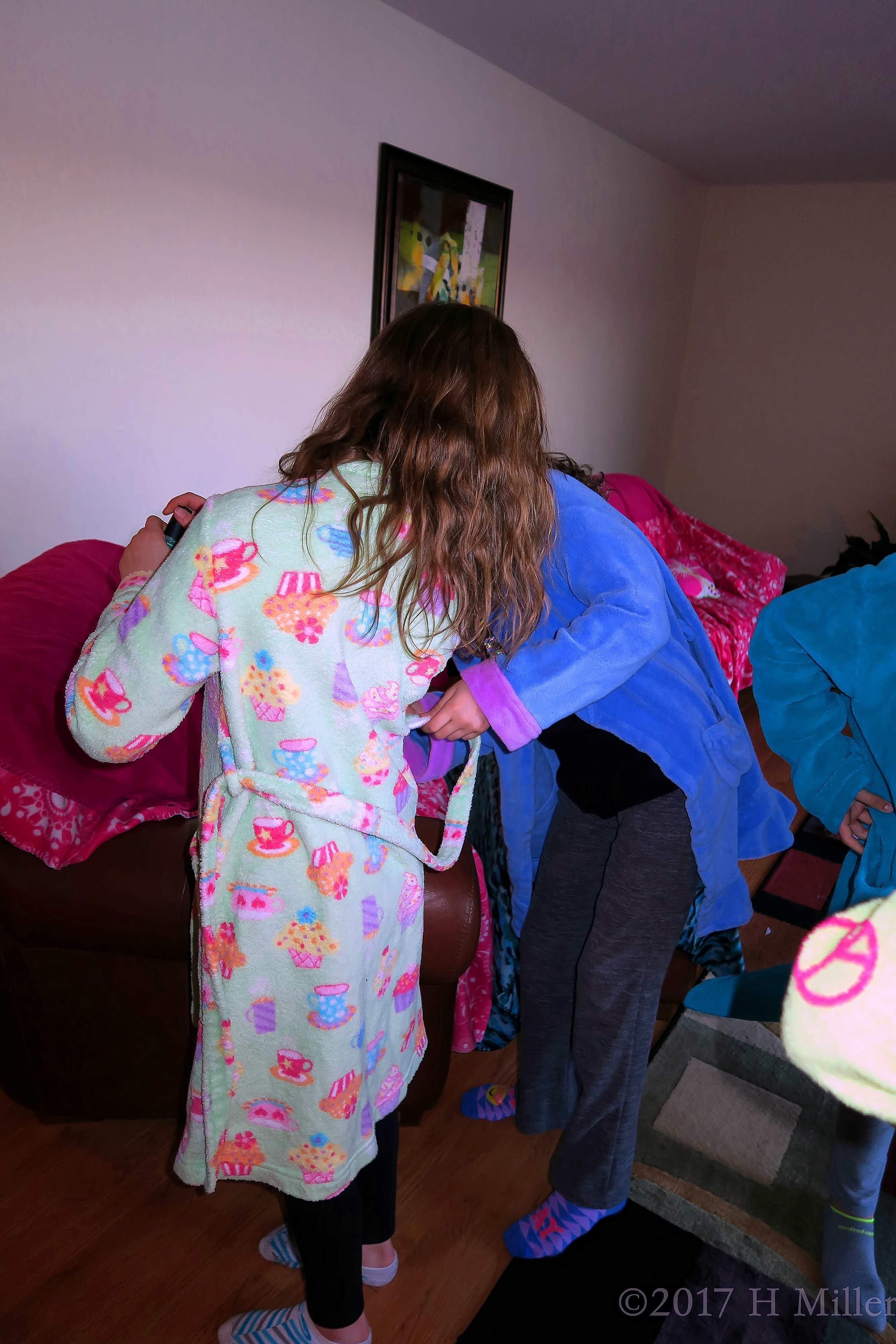 Party Guests Helping Each Other Out With Their Spa Robes Party Guests Helping Each Other Out With Their Spa Robes