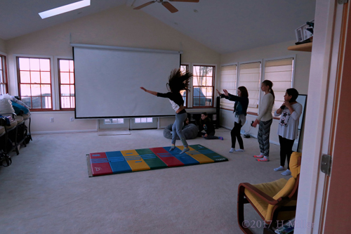 Party Guests Having Fun Playing Games And Doing Gymnastics During A Break From Their Spa Services