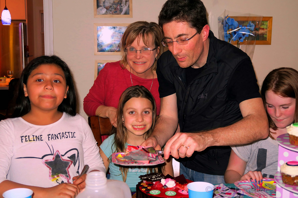 Mom And Dad Taking Pic With The Birthday Girl 