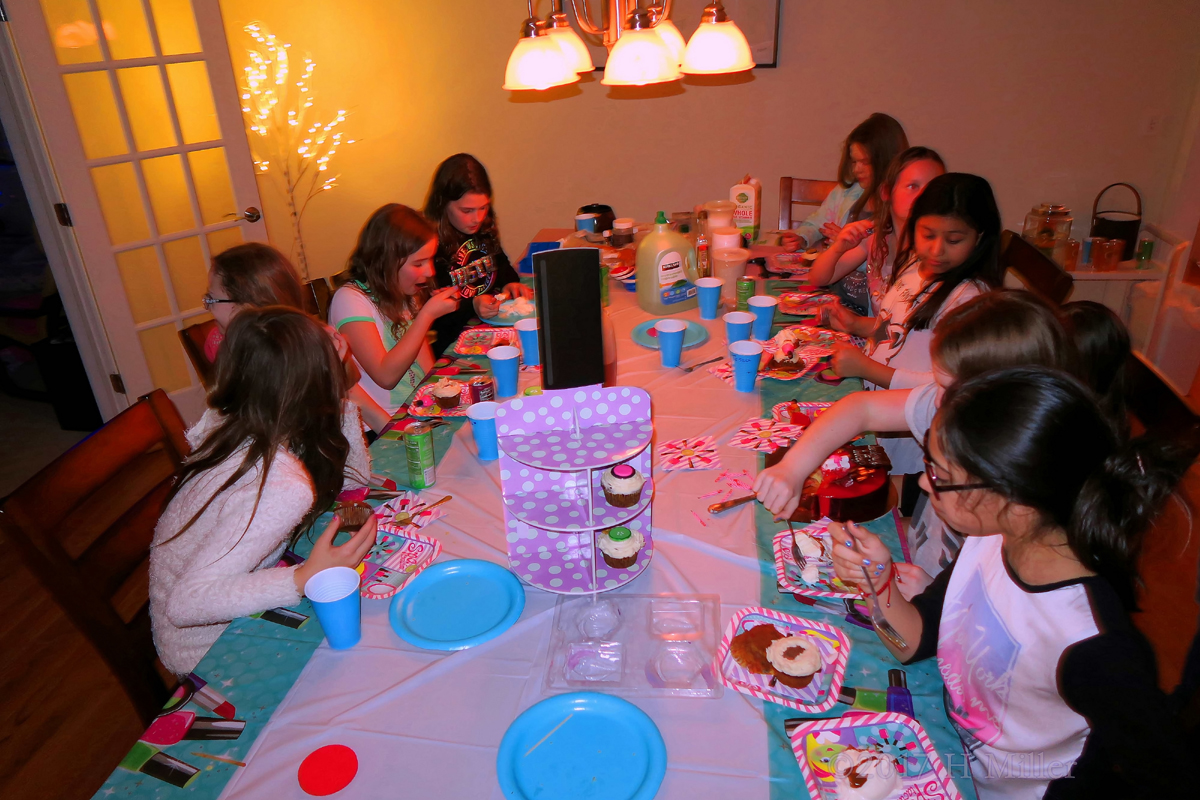 Party Guests Enjoying Birthday Cake And Party Treats 