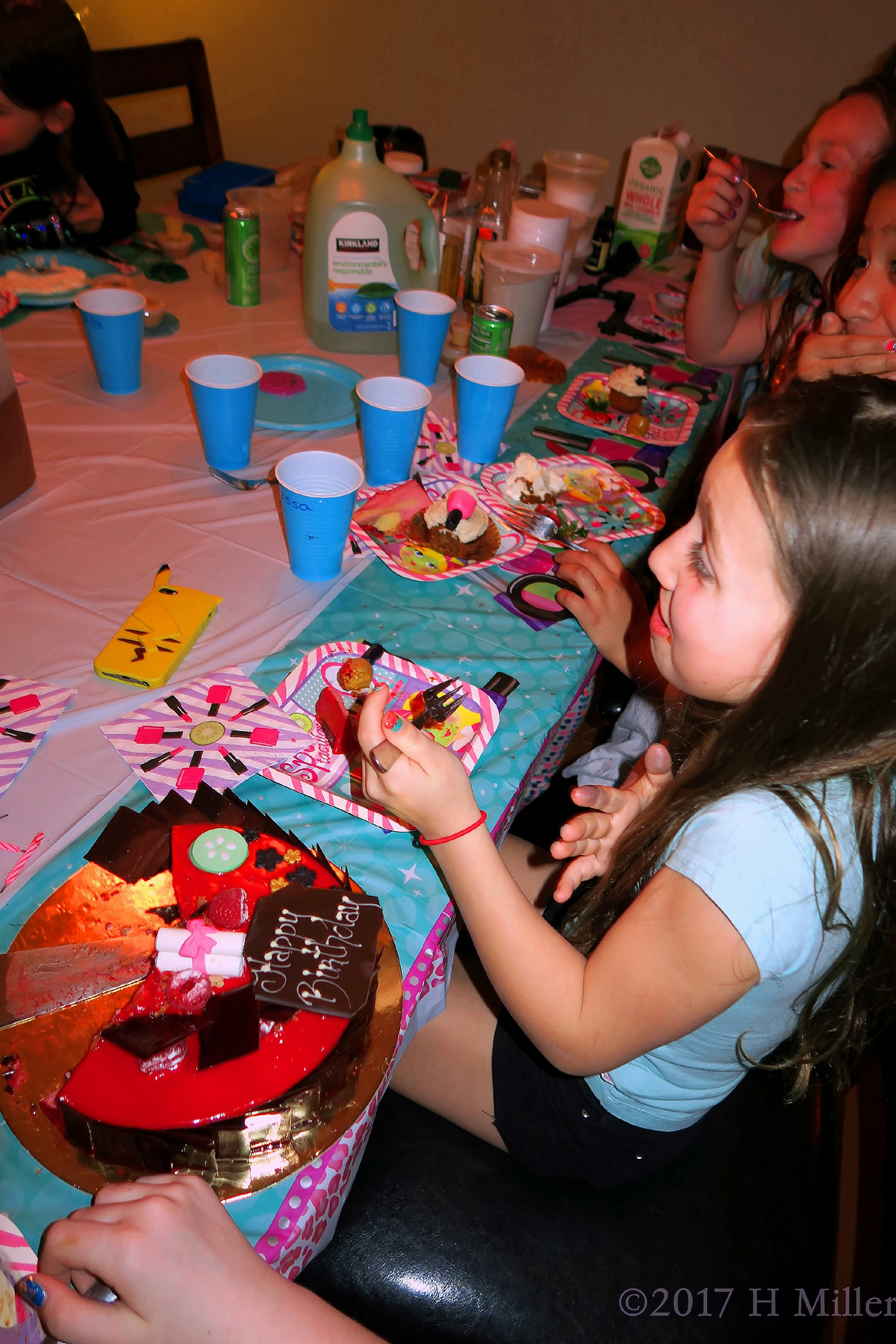 The Birthday Girl And Her Guests Enjoy Cake 