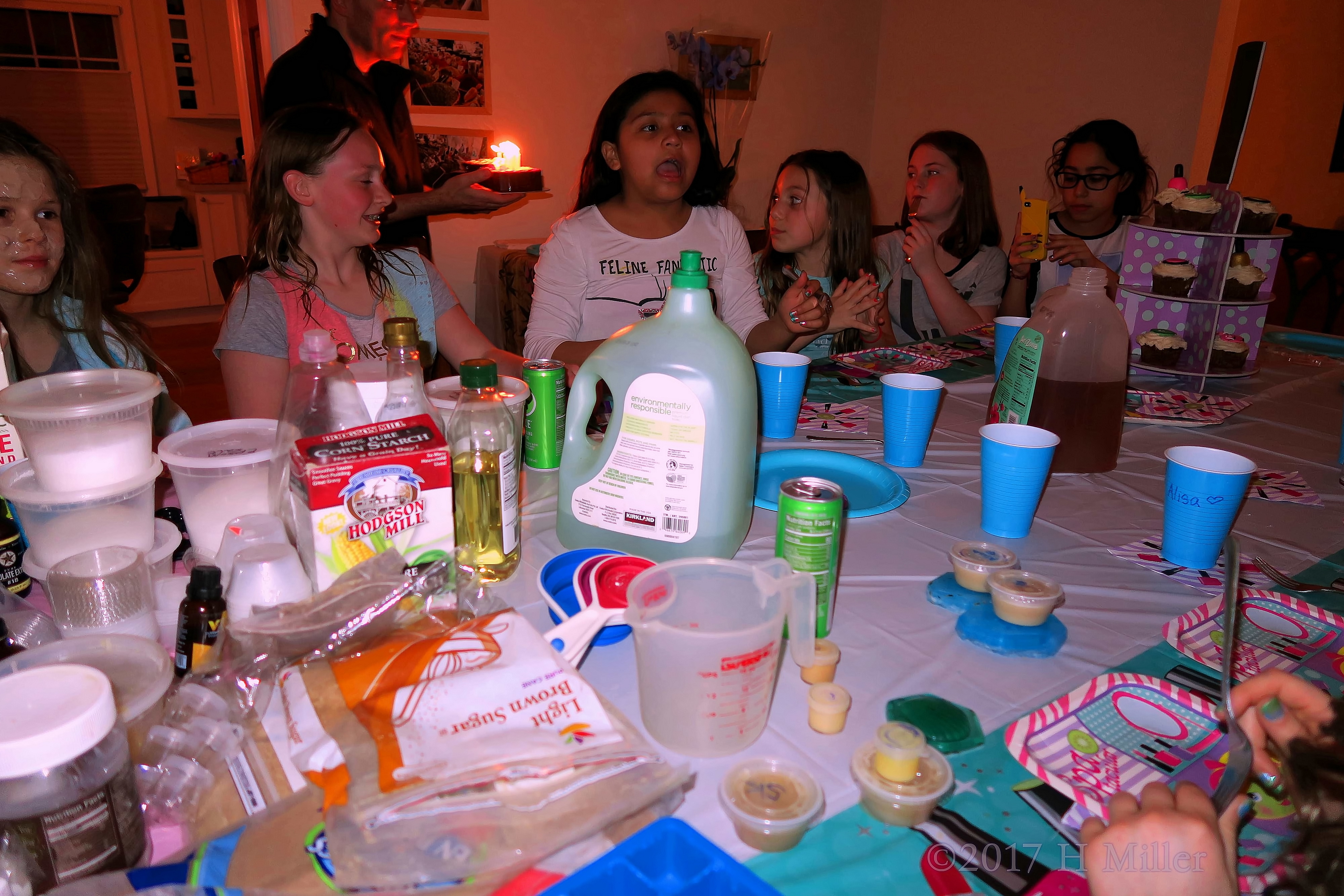 Party Guests Having Fun Making Kids Crafts And Eating Treats 