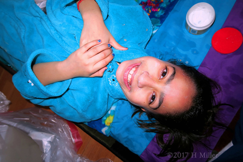All Smiles In Her Comfy Blue Spa Robe With Blue Mani