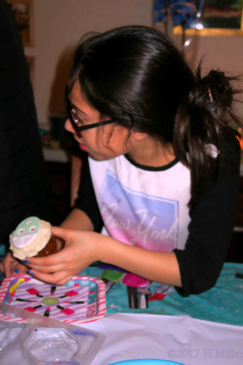 Party Guest Getting Ready To Enjoy Her Cupcake