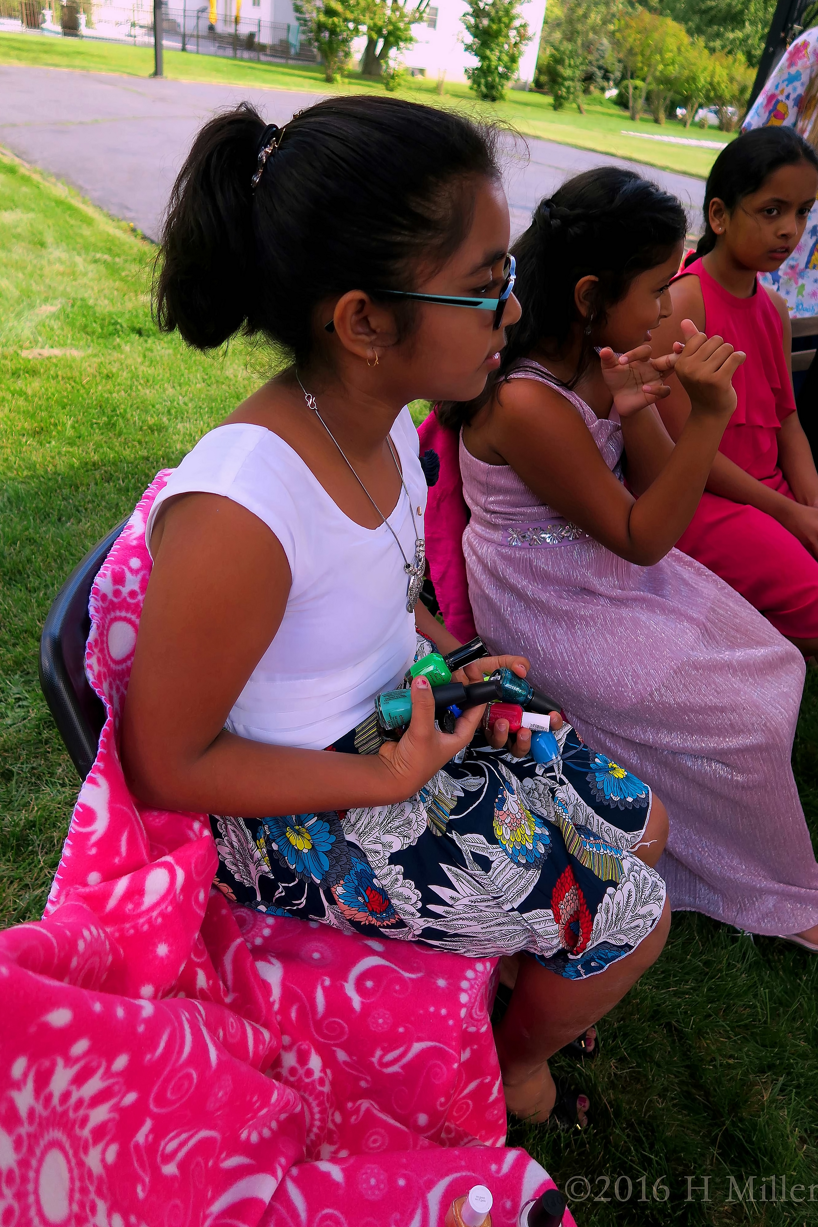 Holding Onto A Pretty Green And Blue Nail Polish Color For Her Pedicure. Holding Onto A Pretty Green And Blue Nail Polish Color For Her Pedicure.