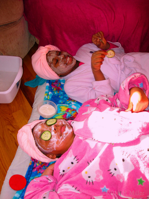 Both Girls Relaxing With Their Facial Masques.