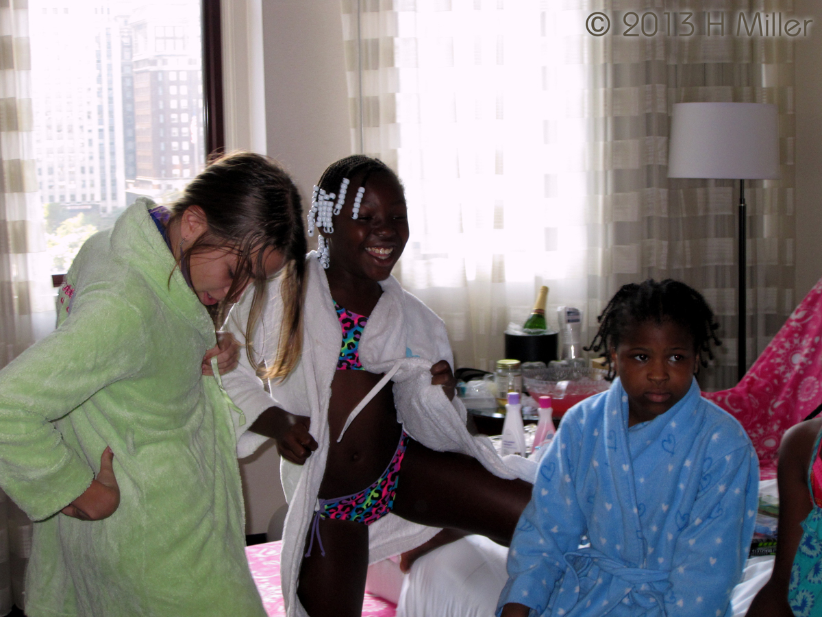 Birthday Girl And Guests Putting On Robes 